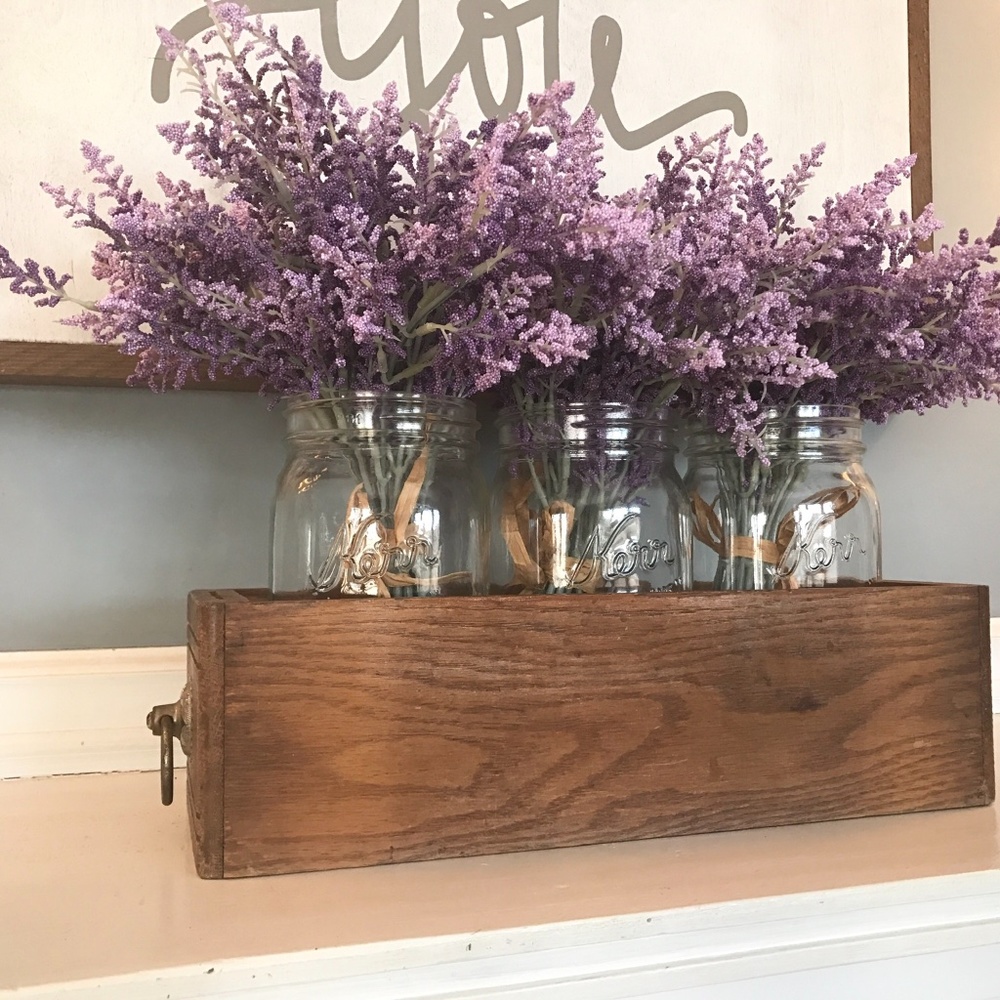 Lavender flowers in Mason jars in antique wood sewing drawer centerpiece vase
